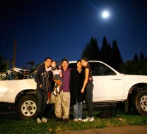 The Mejia family in front of a white pickup truck